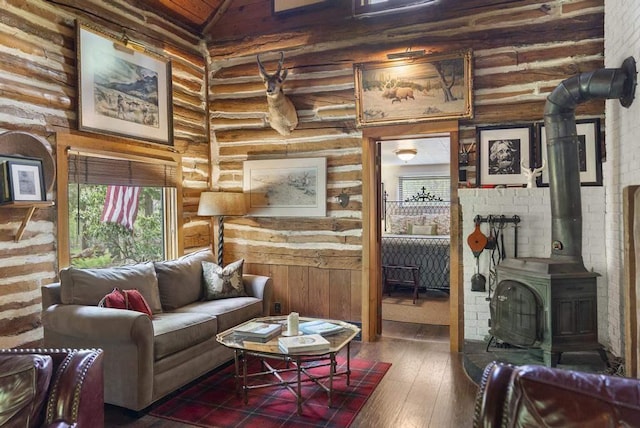 680 N Lake Shore Dr, Harbor Springs, MI 49740 - living area with wood-type flooring, high vaulted ceiling, and a wood stove