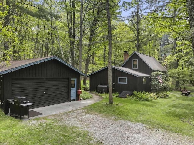 680 N Lake Shore Dr, Harbor Springs, MI 49740 - detached garage with a forest view