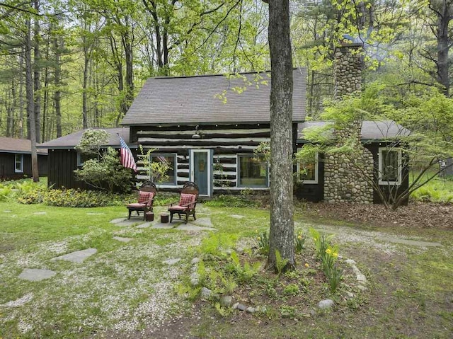 680 N Lake Shore Dr, Harbor Springs, MI 49740 - rear view of property featuring a chimney and roof with shingles