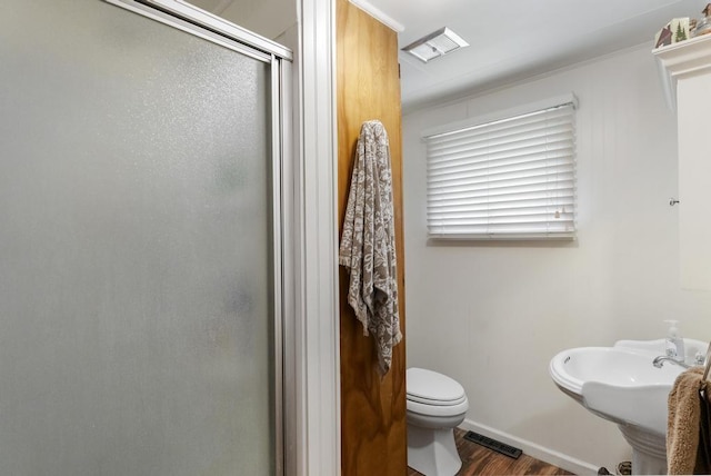 680 N Lake Shore Dr, Harbor Springs, MI 49740 - bathroom with a shower stall, wood finished floors, toilet, and baseboards