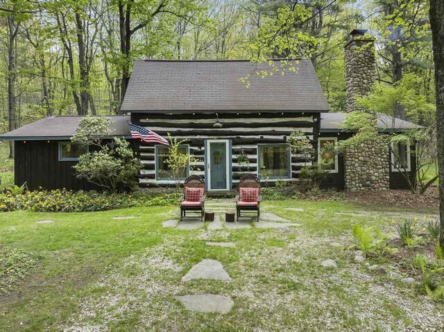 680 N Lake Shore Dr, Harbor Springs, MI 49740 - back of property featuring a chimney, a lawn, and a patio