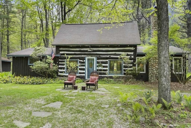 680 N Lake Shore Dr, Harbor Springs, MI 49740 - rear view of house with log exterior and a yard