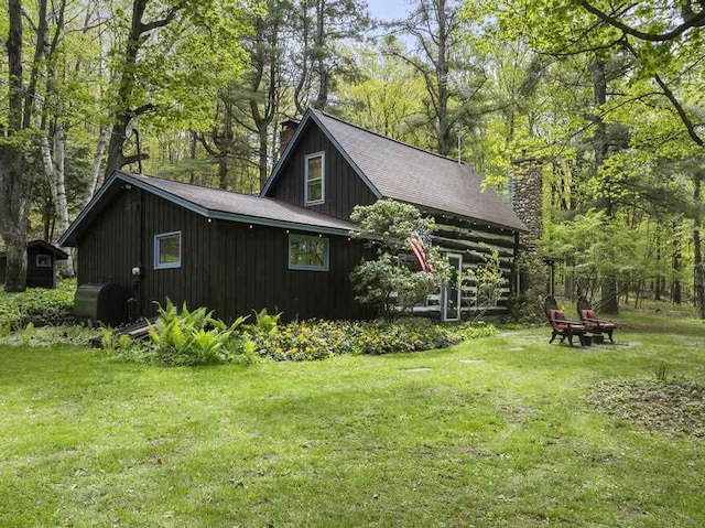 680 N Lake Shore Dr, Harbor Springs, MI 49740 - view of home's exterior featuring a chimney and a lawn