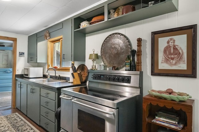 680 N Lake Shore Dr, Harbor Springs, MI 49740 - kitchen featuring electric range, white microwave, a sink, dark countertops, and wood finished floors