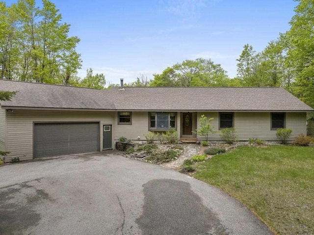 4545 Lintlong Rd, Petoskey, MI 49770 - ranch-style home featuring driveway, an attached garage, and a front lawn