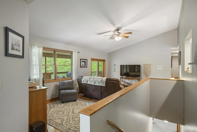 4545 Lintlong Rd, Petoskey, MI 49770 - living room featuring vaulted ceiling, a ceiling fan, and light wood-style floors