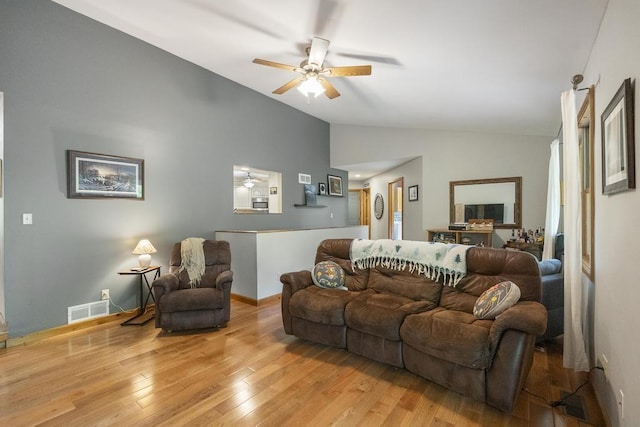 4545 Lintlong Rd, Petoskey, MI 49770 - living area with lofted ceiling, ceiling fan, light wood-type flooring, and baseboards