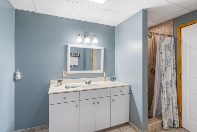 4545 Lintlong Rd, Petoskey, MI 49770 - bathroom with vanity, a drop ceiling, a shower with shower curtain, and tile patterned flooring