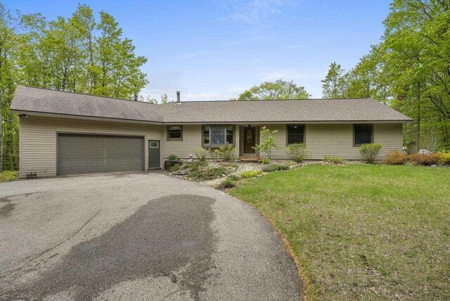 4545 Lintlong Rd, Petoskey, MI 49770 - single story home featuring an attached garage, driveway, and a front yard