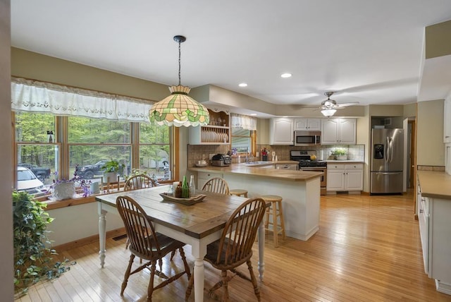 4545 Lintlong Rd, Petoskey, MI 49770 - dining room featuring light wood finished floors, ceiling fan, recessed lighting, and baseboards