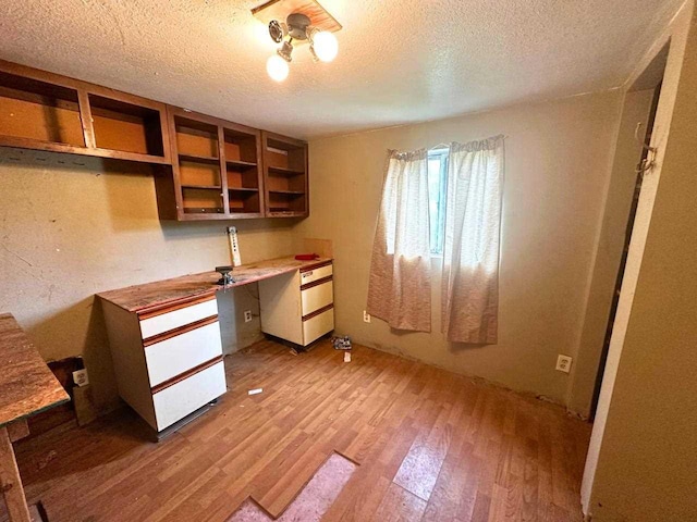 2378 E Old State Rd, East Jordan, MI 49727 - unfurnished office with light wood finished floors and a textured ceiling