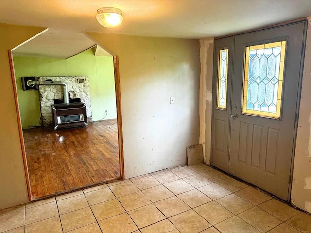 2378 E Old State Rd, East Jordan, MI 49727 - entryway with a wood stove and light tile patterned floors