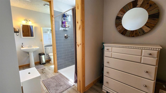 15718 N Blueberry Ln, Paradise, MI 49768 - full bath with toilet, a shower stall, wood finished floors, and baseboards