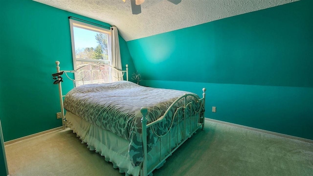 15718 N Blueberry Ln, Paradise, MI 49768 - bedroom featuring a textured ceiling, lofted ceiling, carpet flooring, baseboards, and a ceiling fan