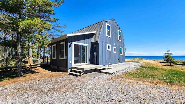 15718 N Blueberry Ln, Paradise, MI 49768 - view of property exterior featuring a water view, board and batten siding, and roof with shingles