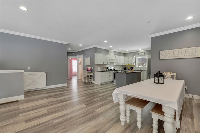 7101 Partridge Pl, Gaylord, MI 49735 - dining room featuring recessed lighting, ornamental molding, baseboards, and light wood-style floors