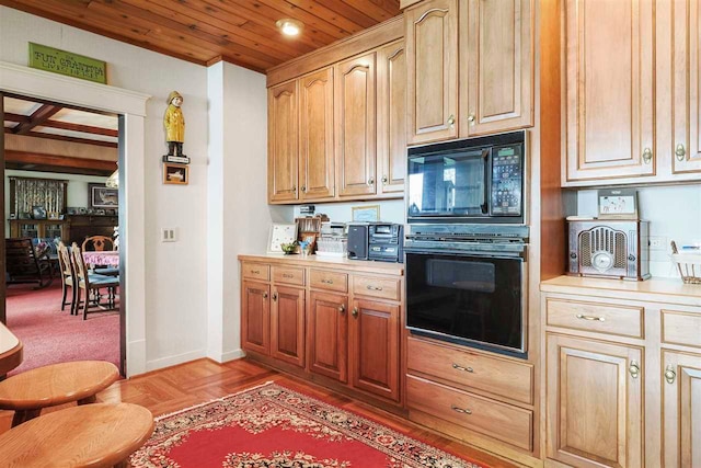 306 E Dixon Ave, Charlevoix, MI 49720 - kitchen with light countertops, wood ceiling, black microwave, and baseboards