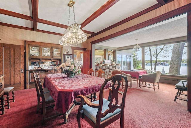 306 E Dixon Ave, Charlevoix, MI 49720 - dining space with a chandelier, carpet flooring, beam ceiling, a water view, and coffered ceiling