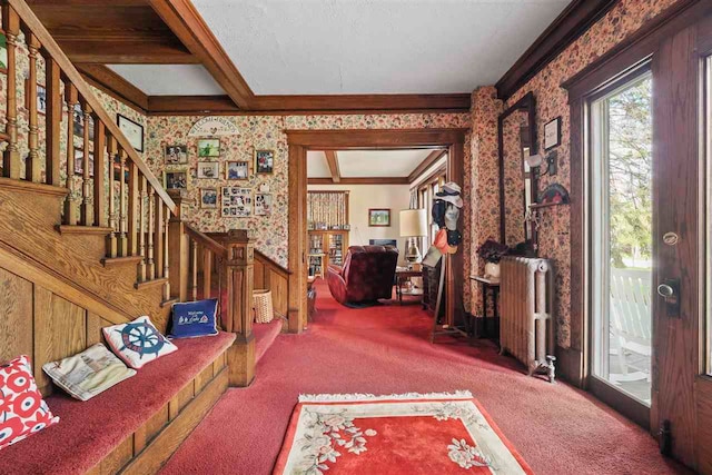 306 E Dixon Ave, Charlevoix, MI 49720 - carpeted entryway with radiator, wallpapered walls, stairs, crown molding, and a wainscoted wall