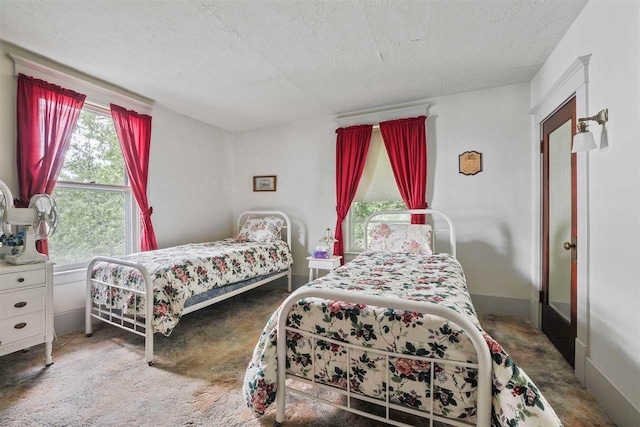 306 E Dixon Ave, Charlevoix, MI 49720 - bedroom featuring multiple windows, a textured ceiling, and baseboards