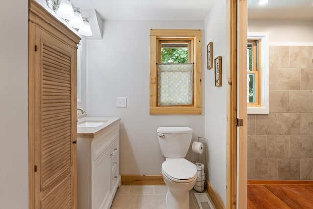 03675 Bc/Ej Rd, East Jordan, MI 49727 - bathroom with baseboards, vanity, toilet, and tile patterned flooring