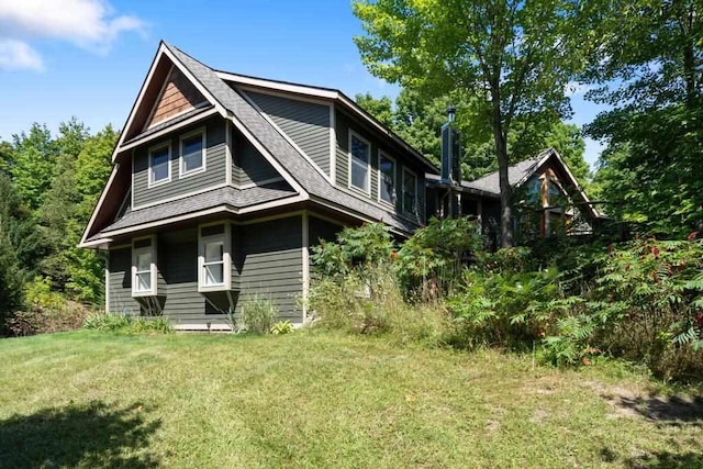 03675 Bc/Ej Rd, East Jordan, MI 49727 - back of property with a yard and roof with shingles