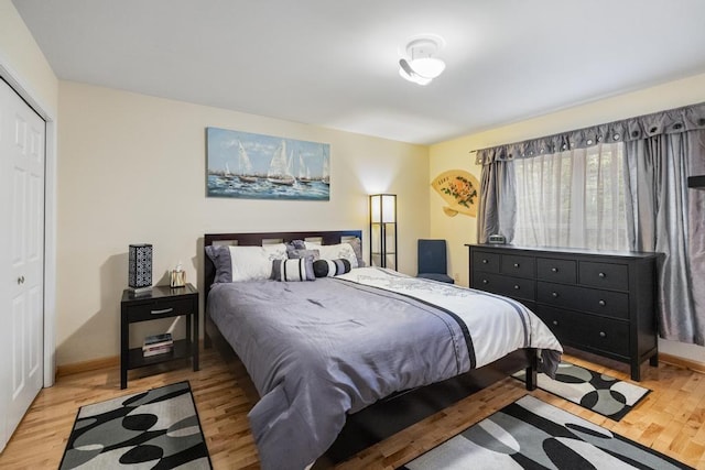 4460 E Fontenoy St, Boyne City, MI 49712 - bedroom featuring wood finished floors, baseboards, and a closet