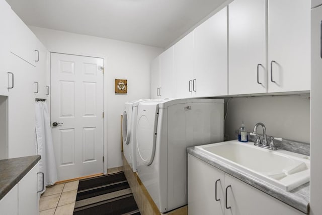 4460 E Fontenoy St, Boyne City, MI 49712 - washroom featuring cabinet space, washer and clothes dryer, and light tile patterned floors