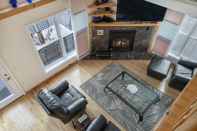 4460 E Fontenoy St, Boyne City, MI 49712 - living area with wood finished floors, a premium fireplace, and plenty of natural light