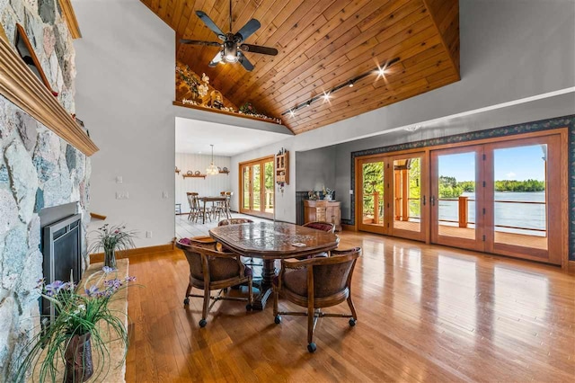 1197 Big Lake Rd, Gaylord, MI 49773 - dining area featuring wooden ceiling, high vaulted ceiling, baseboards, french doors, and a ceiling fan