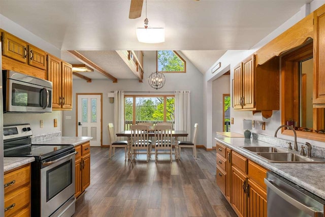 10370 Boyne City Rd, Charlevoix, MI 49720 - kitchen featuring appliances with stainless steel finishes, a sink, light countertops, dark wood-style flooring, and lofted ceiling