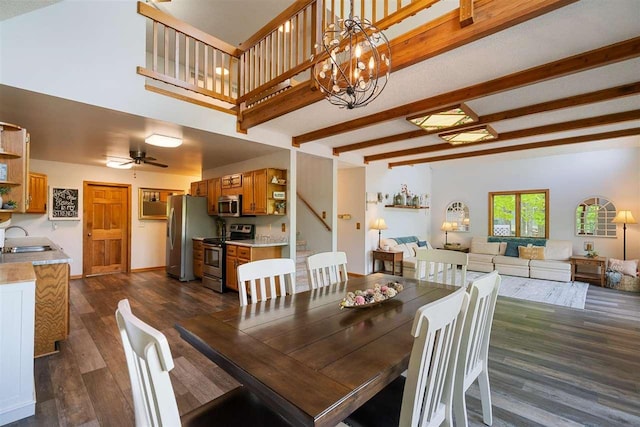 10370 Boyne City Rd, Charlevoix, MI 49720 - dining room with dark wood-style flooring, beam ceiling, a chandelier, and a ceiling fan