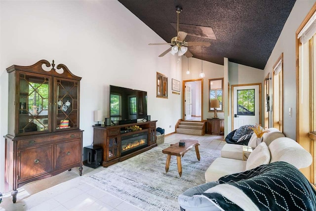 10370 Boyne City Rd, Charlevoix, MI 49720 - living room featuring high vaulted ceiling, a ceiling fan, and tile patterned floors