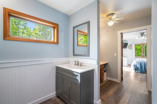 10370 Boyne City Rd, Charlevoix, MI 49720 - ensuite bathroom with vanity, wood finished floors, a wainscoted wall, and a ceiling fan