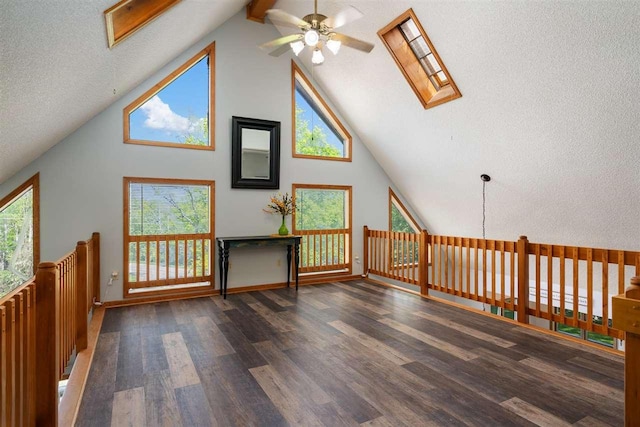 10370 Boyne City Rd, Charlevoix, MI 49720 - additional living space featuring a skylight, ceiling fan, wood finished floors, high vaulted ceiling, and beam ceiling