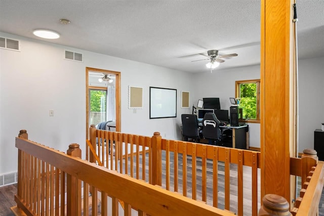 10370 Boyne City Rd, Charlevoix, MI 49720 - office area with a ceiling fan, healthy amount of natural light, a textured ceiling, and wood finished floors