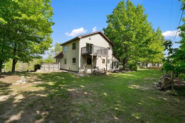 10370 Boyne City Rd, Charlevoix, MI 49720 - back of house featuring a balcony and a yard