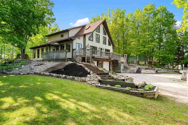 10370 Boyne City Rd, Charlevoix, MI 49720 - rear view of house with stairs, a deck, and a lawn