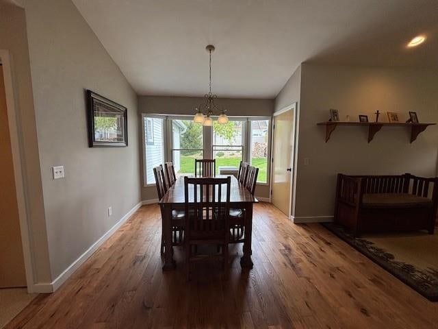 1020 Waukazoo, Petoskey, MI 49770 - dining room with baseboards, wood finished floors, recessed lighting, a chandelier, and vaulted ceiling