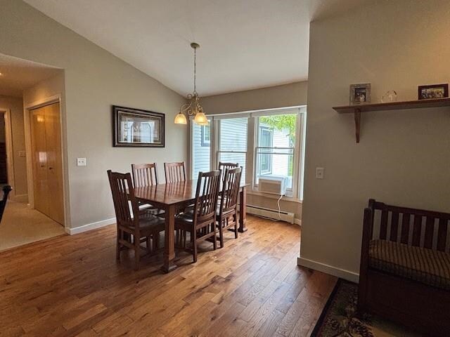 1020 Waukazoo, Petoskey, MI 49770 - dining space with wood finished floors, vaulted ceiling, baseboards, and baseboard heating
