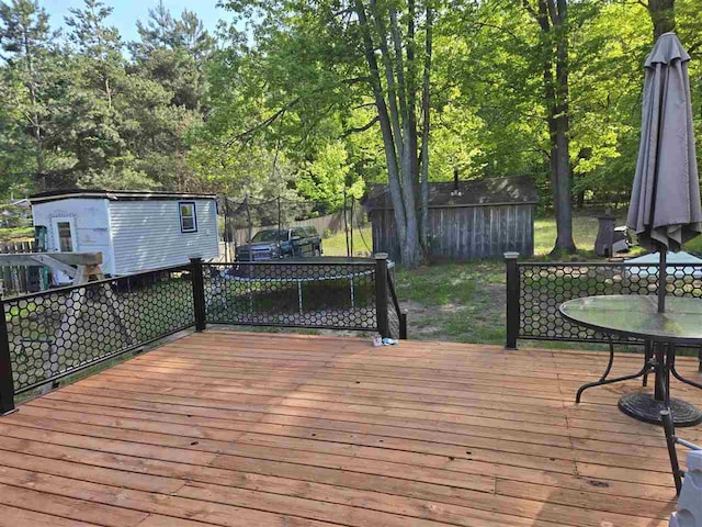05671 N M-66 N, Charlevoix, MI 49720 - wooden terrace featuring outdoor dining space and view of scattered trees