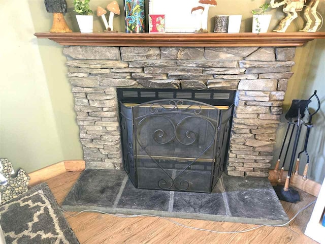 05671 N M-66 N, Charlevoix, MI 49720 - detailed view of a stone fireplace and wood finished floors