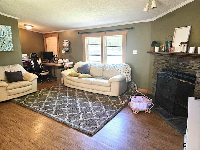 05671 N M-66 N, Charlevoix, MI 49720 - living room featuring ornamental molding, wood finished floors, a textured ceiling, a desk, and a stone fireplace