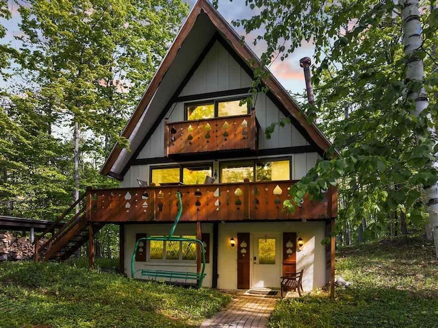 426 Chamonix Ln, Harbor Springs, MI 49740 - rear view of property featuring stairway and a wooden deck