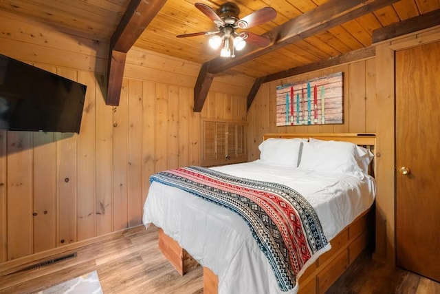 426 Chamonix Ln, Harbor Springs, MI 49740 - bedroom with wooden ceiling with exposed beams, wood walls, and wood finished floors