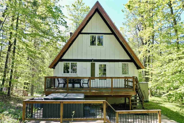 426 Chamonix Ln, Harbor Springs, MI 49740 - rear view of property with board and batten siding, a wooden deck, and stairs