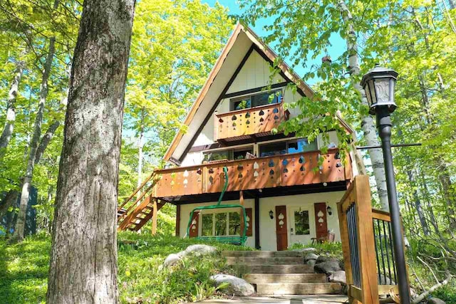 426 Chamonix Ln, Harbor Springs, MI 49740 - view of front of home with stairs and stucco siding