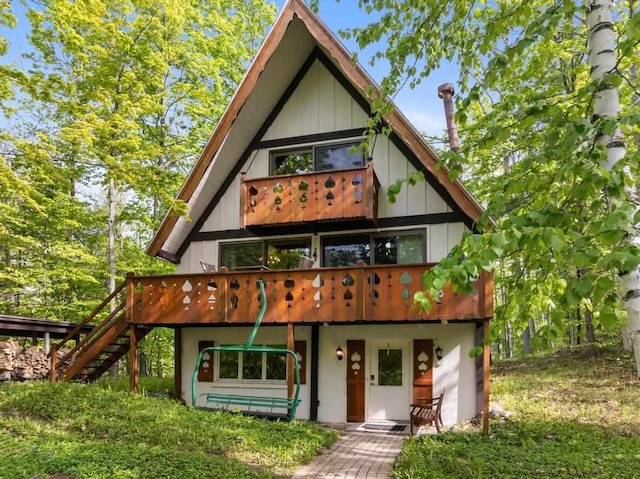 426 Chamonix Ln, Harbor Springs, MI 49740 - view of front of home with stairway and a wooden deck