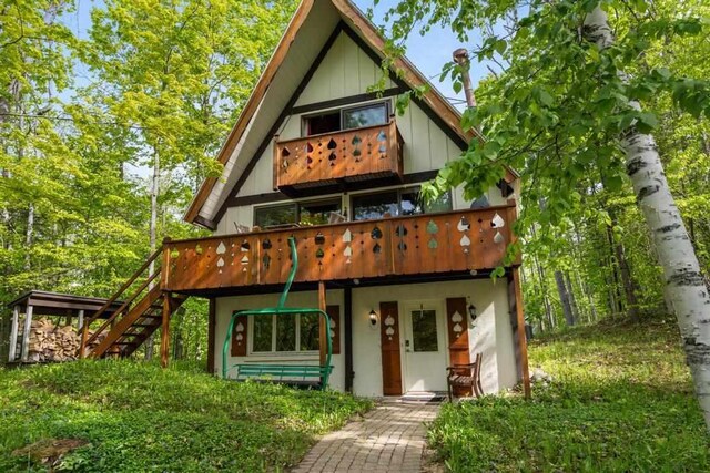 426 Chamonix Ln, Harbor Springs, MI 49740 - rear view of property with stairs and a wooden deck