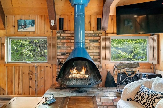 426 Chamonix Ln, Harbor Springs, MI 49740 - detailed view of a wood stove, wooden walls, and beam ceiling